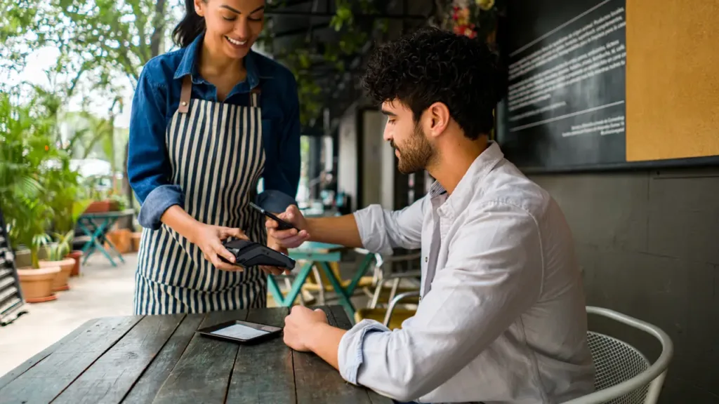  a men paying bill with mobile coffee app, showcasing a Digital Innovation in Coffee