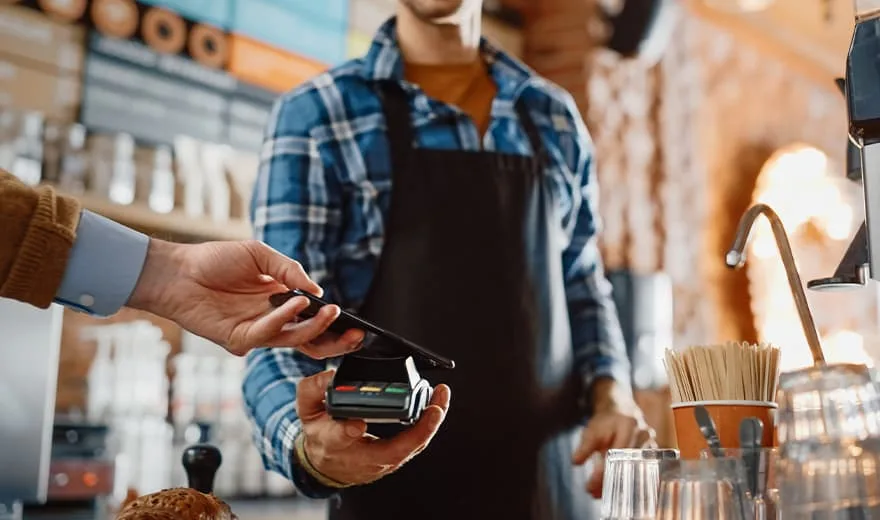 a man paying bill with Mobile Payment Solutions for Coffee Shops