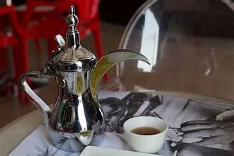 Sharjah coffee house scene with a kettle and cup on the table