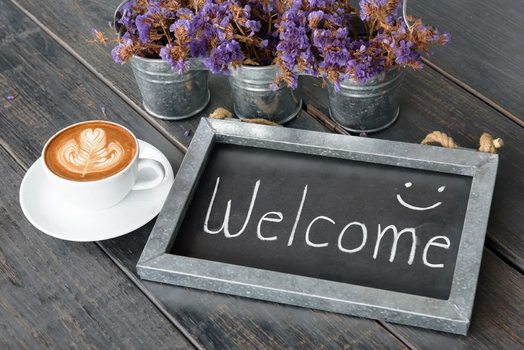 a coffee cup with welcome board for Rewards Program