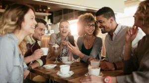 friends laughing in coffee shop iStock 611178972